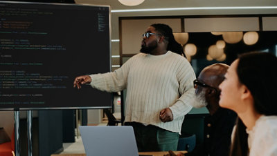 Man giving a presentation to co-workers in a business meeting.
