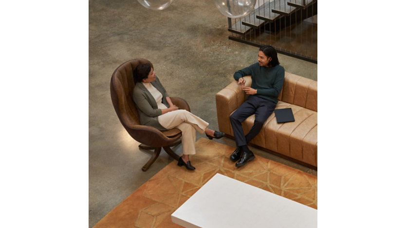 Two co-workers having a conversation.