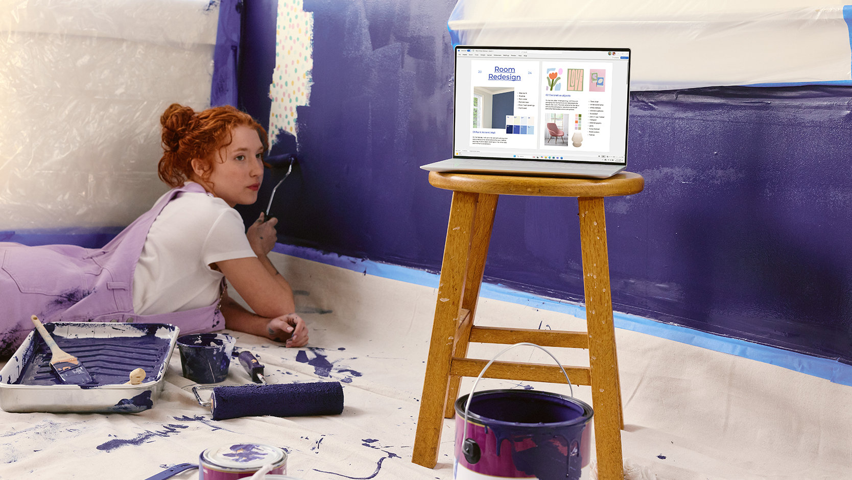 A young person paints a wall next to a laptop showing a presentation, suggesting the creative capabilities of apps in a Microsoft 365 subscription.
