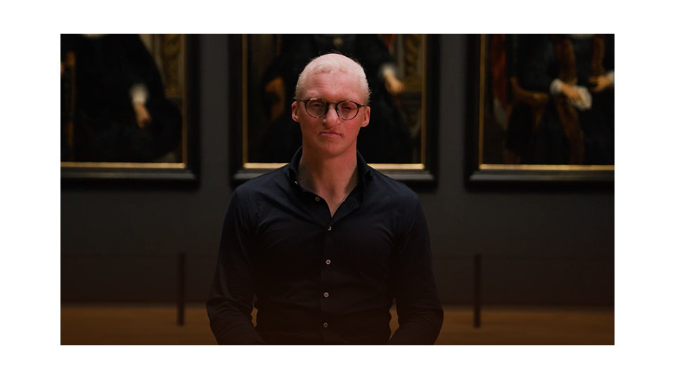 A Microsoft engineer stands in front of paintings at the Rijksmuseum.