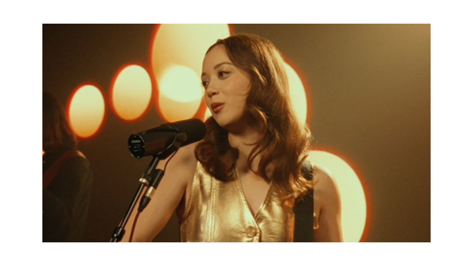 The musician Laufey, singing on a stage