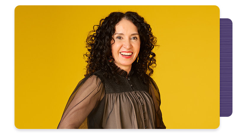 Image of Gabriela standing with a smile on her face and her hands on her hips