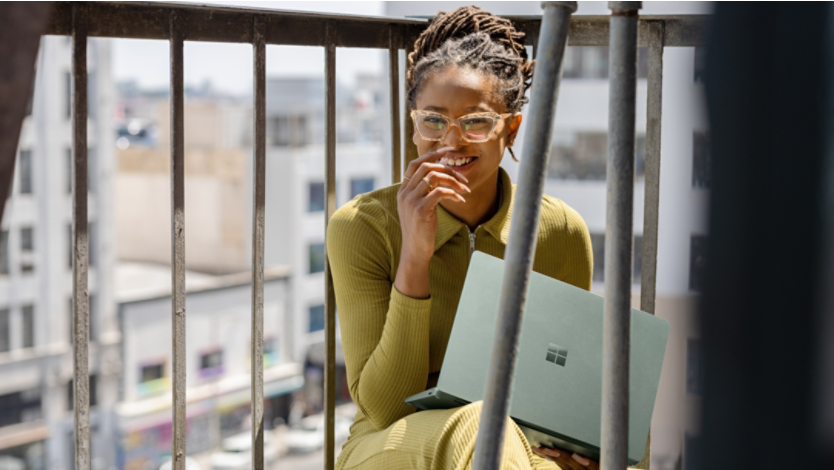 Woman holding a Surface laptop 5 on her lap