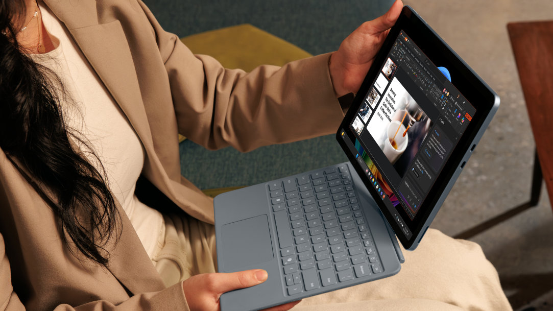 An image of a woman attaching a Surface Pro keyboard to a Surface Pro, Copilot+ PC