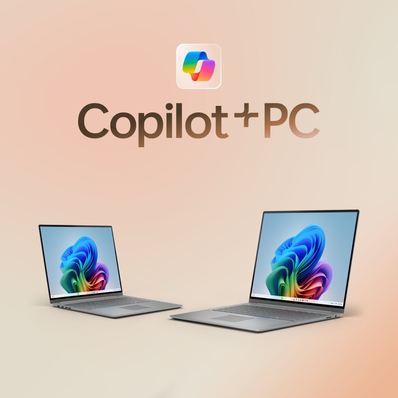 Two open laptops with rainbow bloom screens with a large Copilot logo above them, on a light peach gradient background