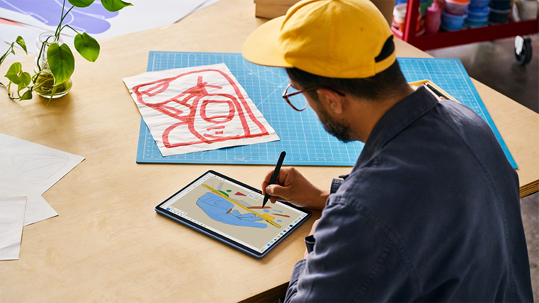 Image of an artist using a stylus pen to draw design ideas on a Surface Pro