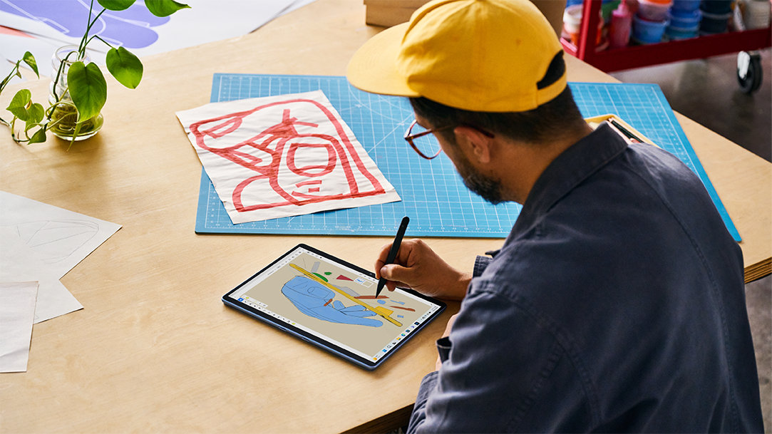 Image of an artist using a stylus pen to draw design ideas on a Surface Pro