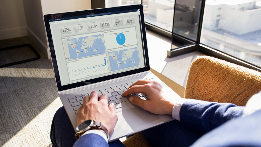 A person using a Surface laptop and wireless mouse