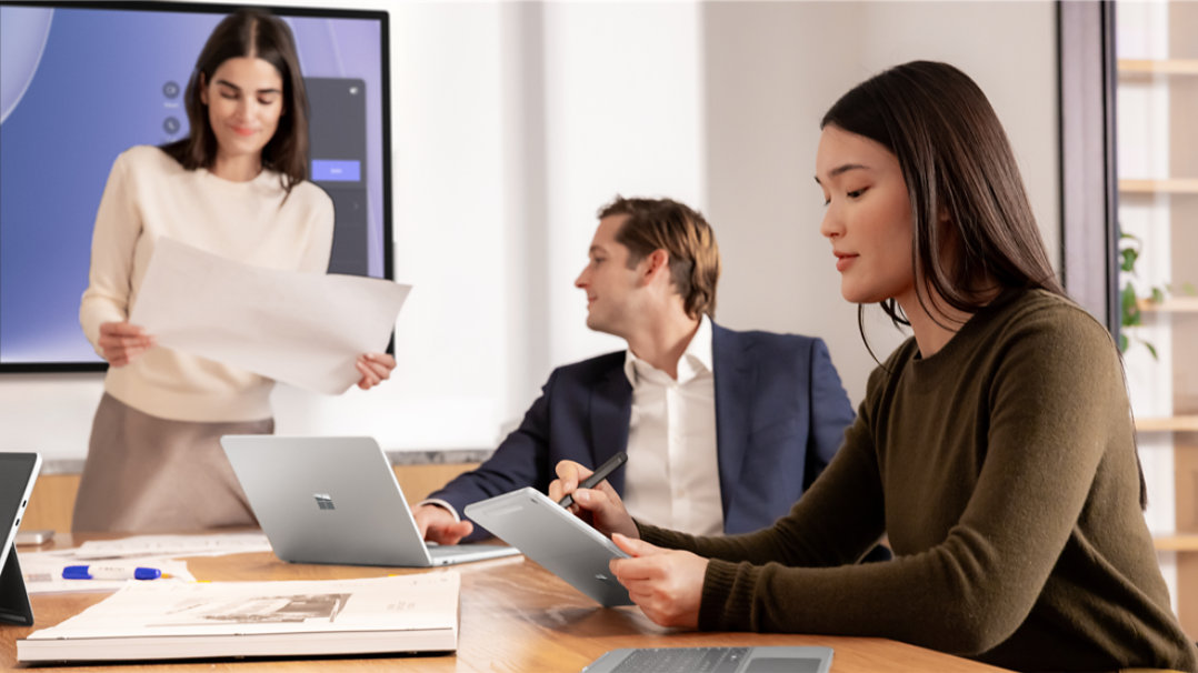 Surface Laptop Studio is observed with various accessories on an office desk