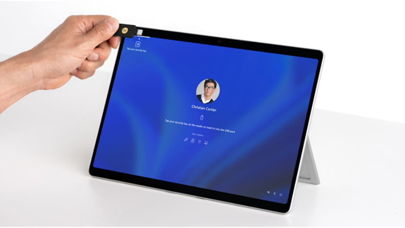 Render of Surface Pro 10 and an NFC device being held up to the integrated NFC reader