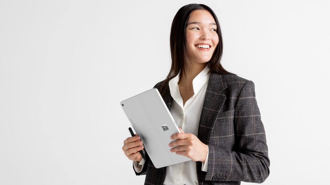 An image of a woman holding a Surface Pro, Copilot+ PC