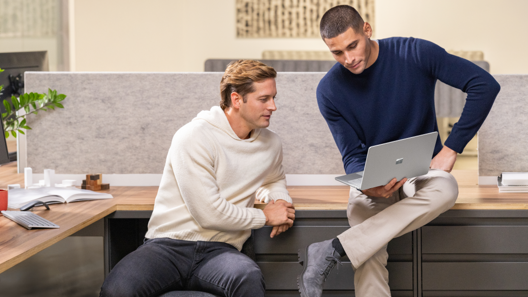Two men collaborating with a Microsoft Surface Laptop
