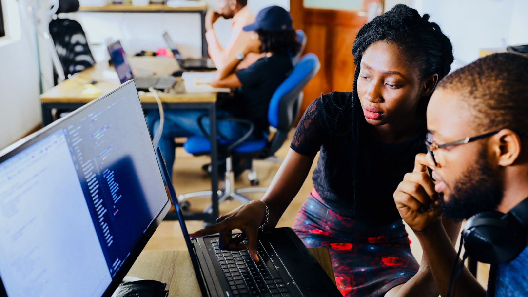 Woman and man working in front of a computer