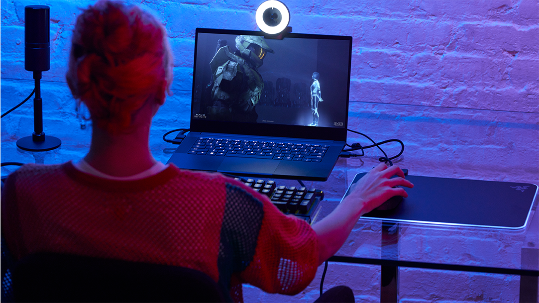 Young adult female gaming in Halo on her PC