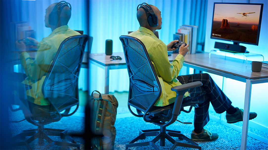 Young adult male gaming using gaming keyboard and mouse in Xbox game pass
