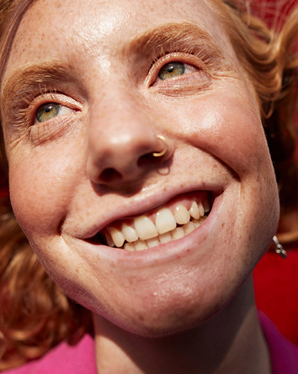 A close up of a person’s smiling face