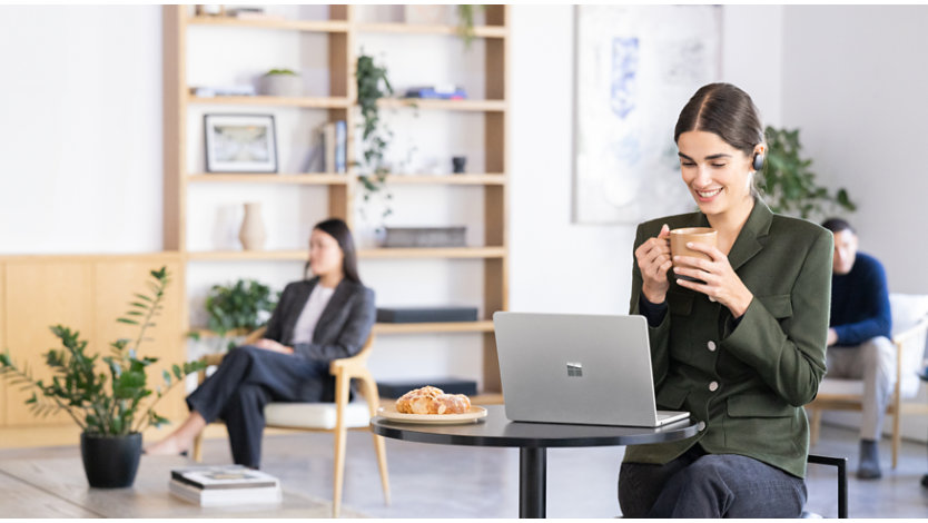 Person using Surface Laptop in coffee shop