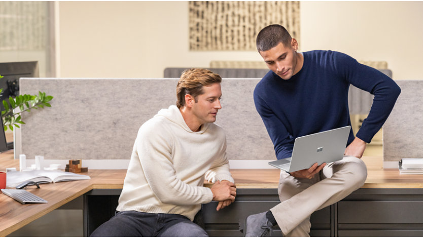 People collaborating in office with Surface Laptop