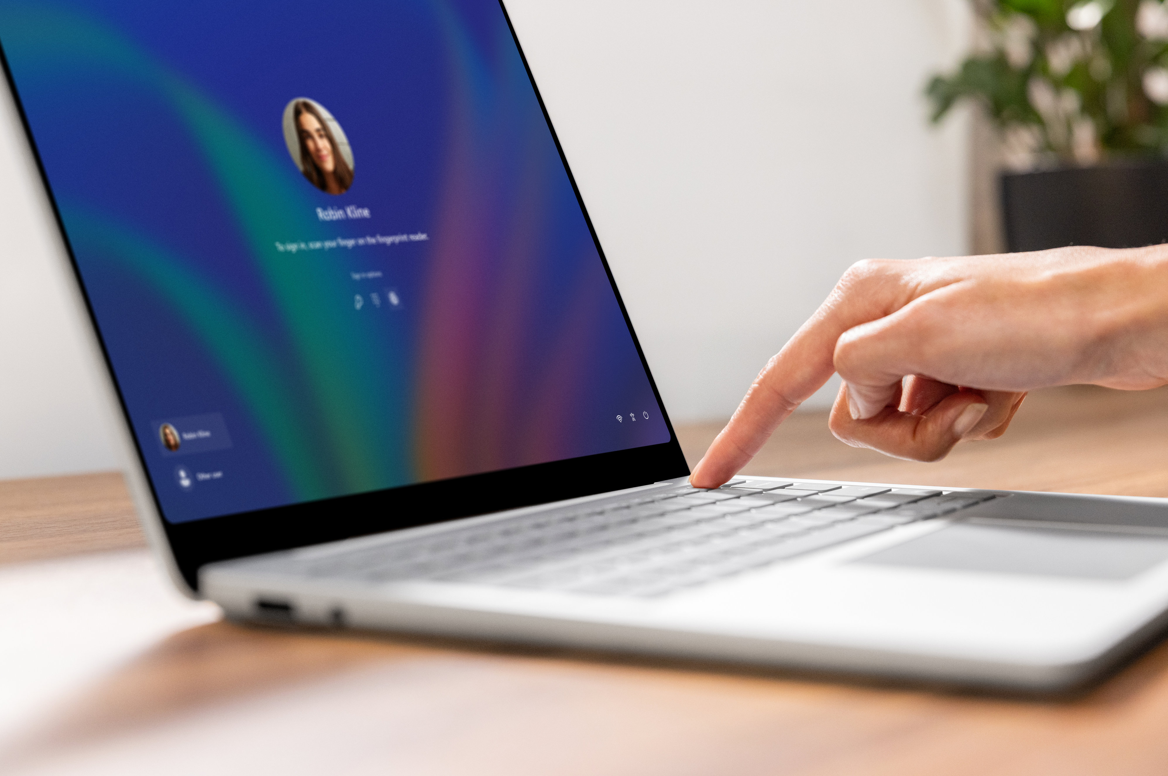 Person logging into Surface Laptop with fingerprint