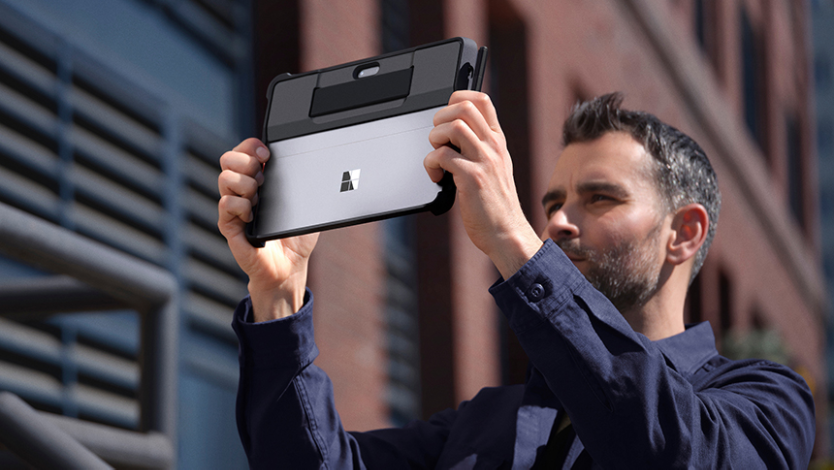 A person uses their Surface Go 4 to take a photo