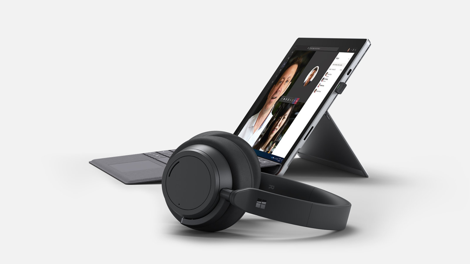 Side profile of a Surface Pro 7+ with Surface Headphones 2+ in the foreground